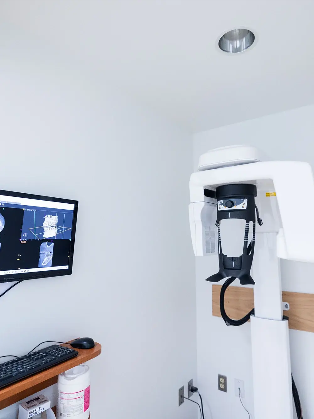 CBCT 3D dental imaging machine in modern Flint dental office with monitor display.