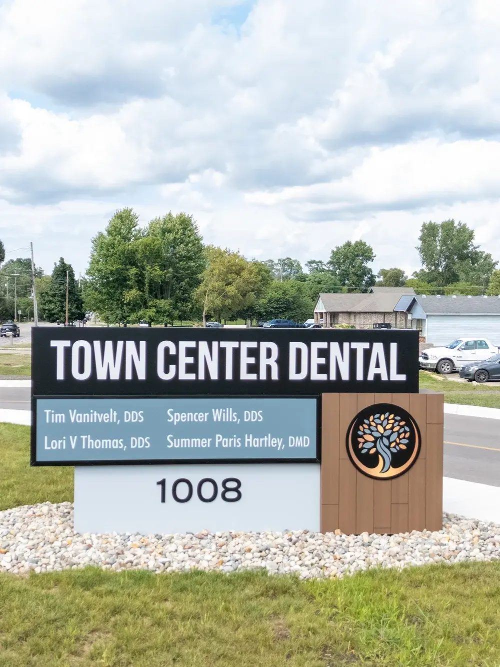 Town Center Dental exterior sign at 1008 address featuring dentist names and tree logo.