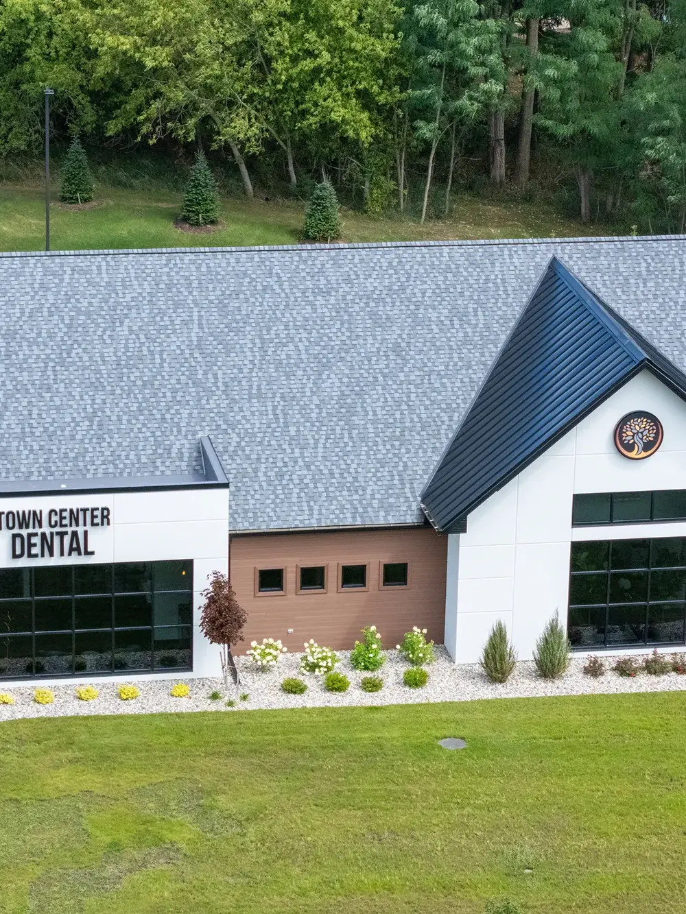 Town Center Dental clinic exterior with modern architecture and manicured landscaping in Flint, Michigan.